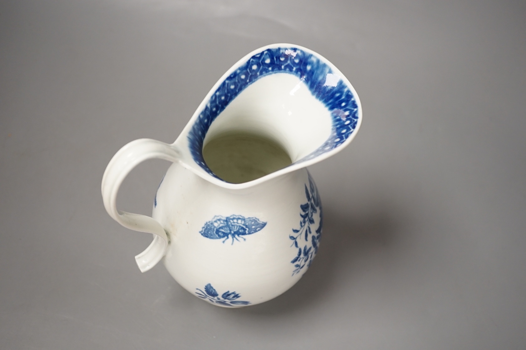 A Worcester French style water ewer decorated in under-glaze blue with fir cones and rose hips c. 1775, 21cm
